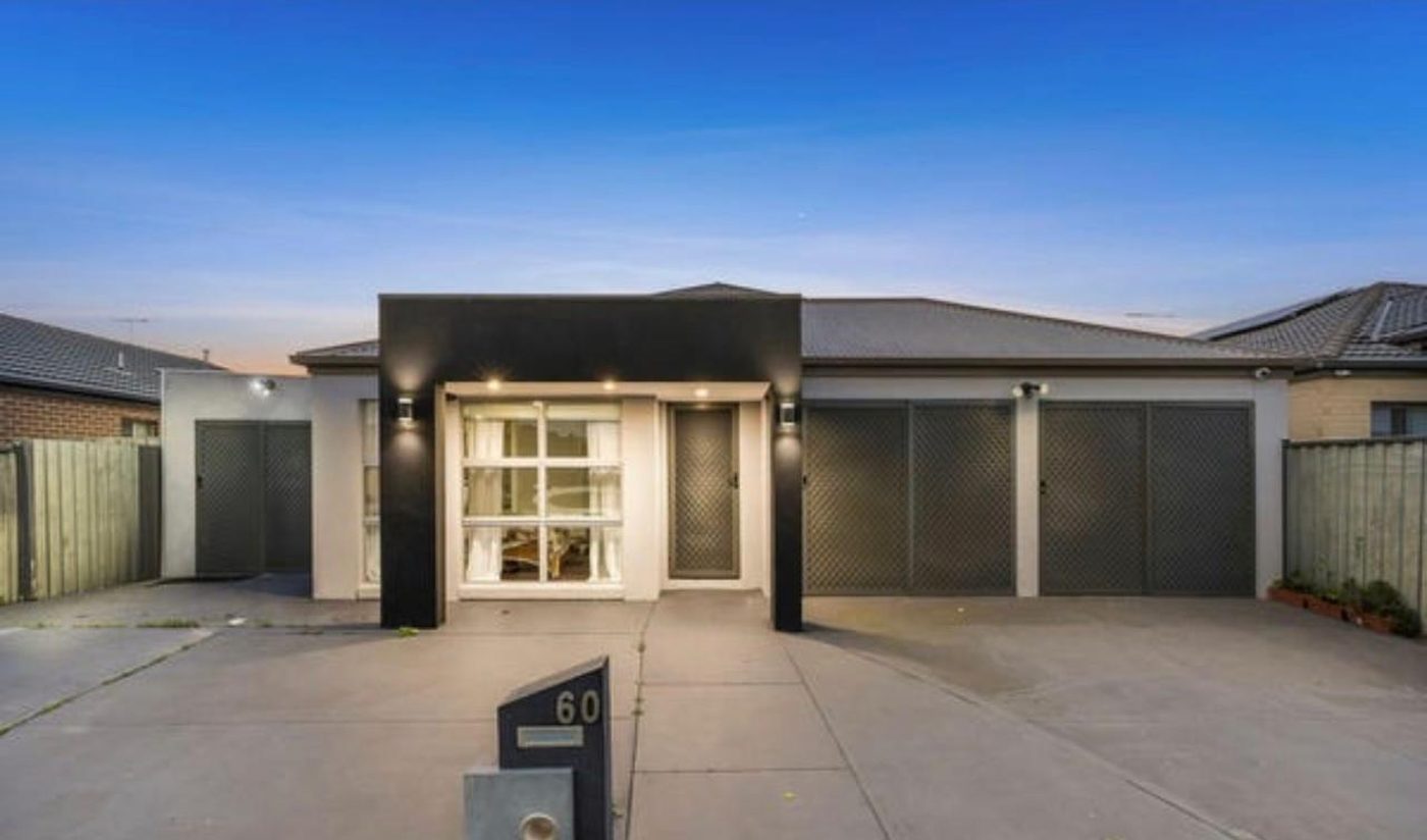 Modern rendered home with a dark feature facade and double garage in Truganina, Victoria