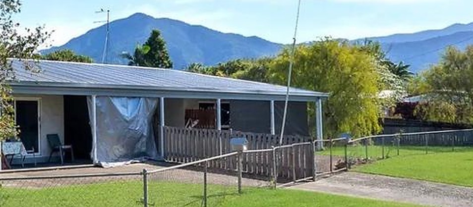 Single storey home with a long front verandah and mountain views behind it, in Edmonton, Queensland