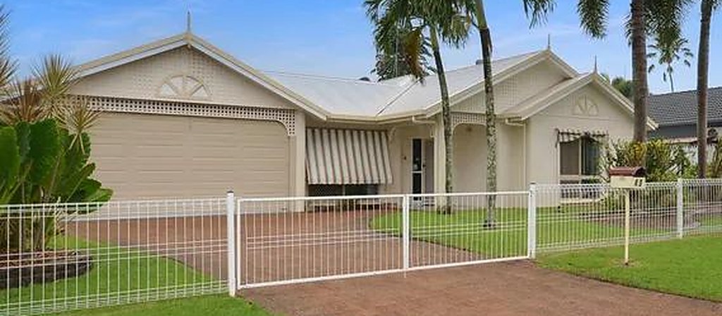 Rendered home with a double garage, window awnings and a white front fence in Mount Sheridan, Queensland