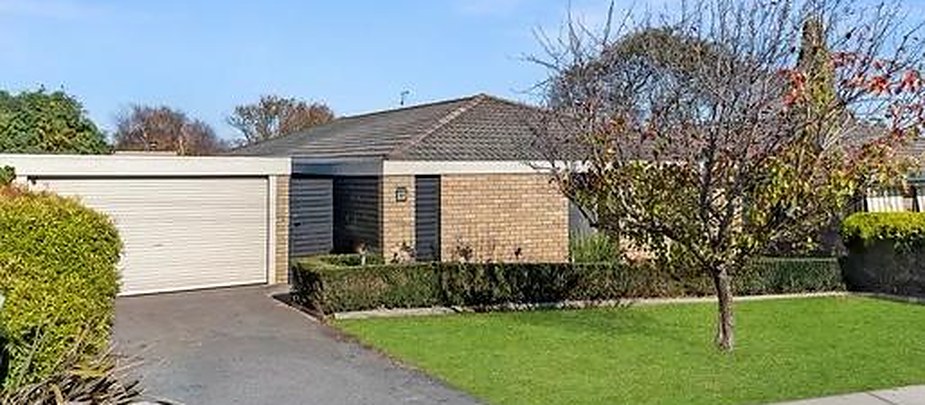 Brick home with a tiled roof, single garage and a clipped hedge in Warrnambool, Victoria